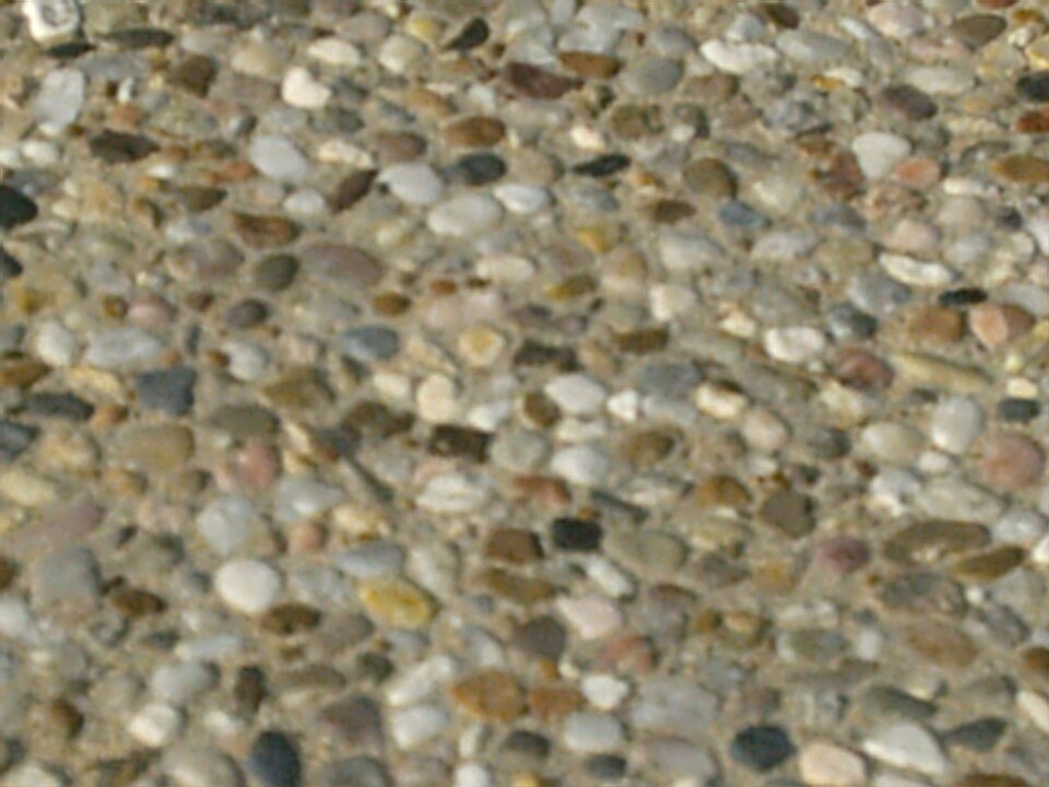 Small rounded pea gravel stones in mixed tan and gray colors